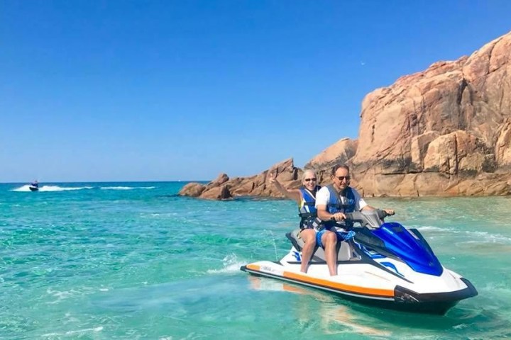 a person riding on the back of a boat in the water