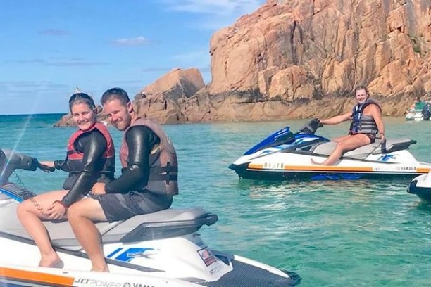a person riding on the back of a boat in the water