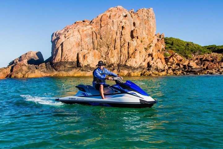a man riding a surfboard on top of a mountain