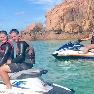 A group of riders sitting on their jet skis