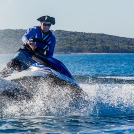 A man tearing up the waves on his jet ski