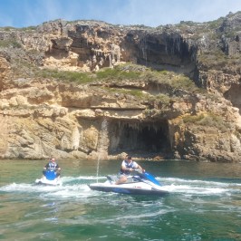 A group of riders cruising by the rock formations