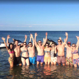 A tour group waving at the camera