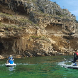 A tour group exploring the rock formations while on their jet ski tour