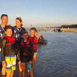 A family taking a picture in the sunset after a tour