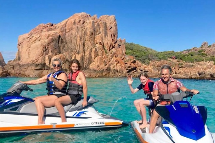 A family of 4 enjoying their jet skis